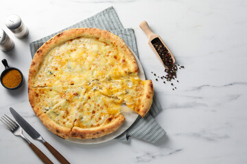 Delicious cheese pizza served on white marble table, flat lay. Space for text
