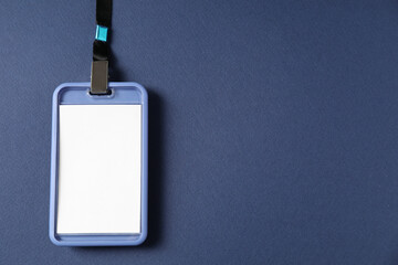 Blank badge with string on blue background, top view. Space for text