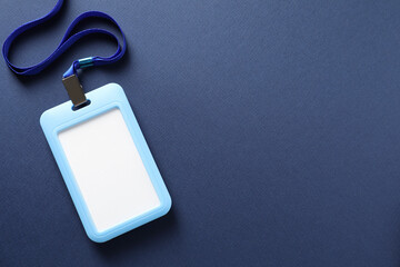 Blank badge with string on blue background, top view. Space for text