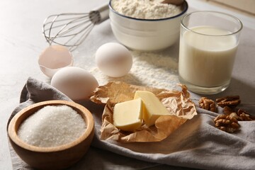 Different ingredients for dough on table, closeup