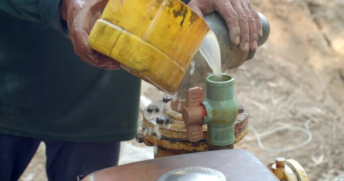 Add water to the water pump pipe before starting the engine.The water pump is working.The water pump uses an old diesel engine.