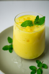 refreshing summer drink decorated with peppermint leaves - mango lassi drink