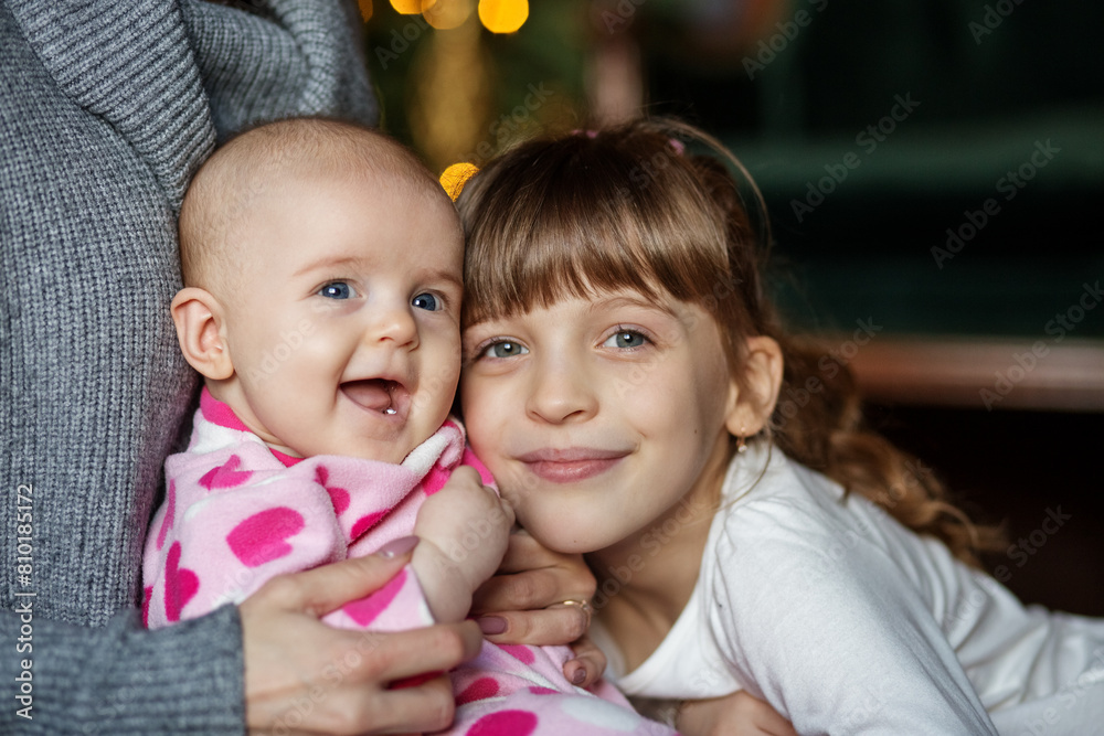 Wall mural sisters smiling together in cozy setting