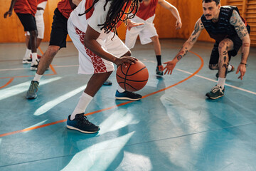 Cropped shot of a diverse professional players playing basketball in a hall