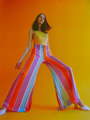 Young stylish woman model posing for edgy and modern fashion editorial. Conceptual photo in vivid colors. Haute couture contemporary trends