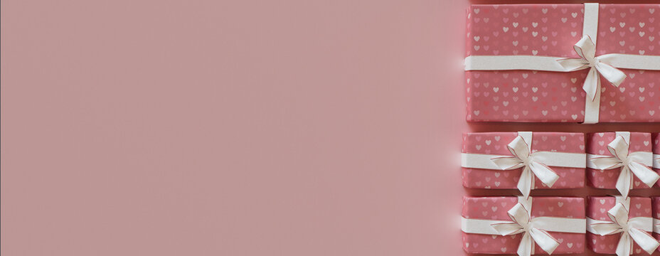 Romantic Wallpaper with Valentine's Day Presents Precisely arranged in a Grid. Modern Pink and White banner with copy-space.