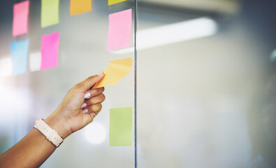 Hand, sticky note and glass wall for brainstorming solution for tech startup or moodboard, project...