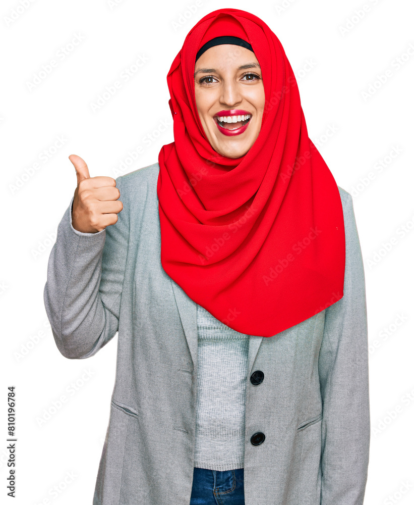 Wall mural beautiful hispanic woman wearing traditional islamic hijab scarf smiling happy and positive, thumb u