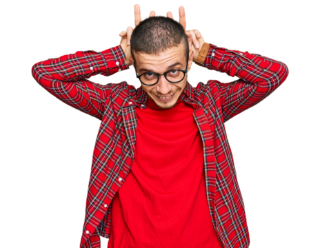 Hispanic young man wearing casual clothes posing funny and crazy with fingers on head as bunny ears, smiling cheerful