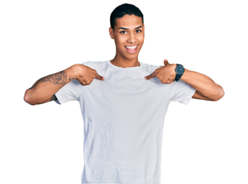 Young hispanic man wearing casual white t shirt looking confident with smile on face, pointing oneself with fingers proud and happy.