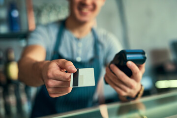 Waiter, hand and card for payment at cafe with client purchase for order, shopping and sale for checkout with machine. Business, man and customer with service, finance and credit for online promotion