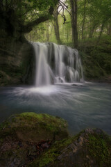 Waterfall of Altube inside a beech forest in the province of Alava, in the Basque Country, on a spring morning
