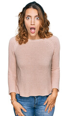 Beautiful young caucasian woman wearing casual sweater afraid and shocked with surprise and amazed expression, fear and excited face.