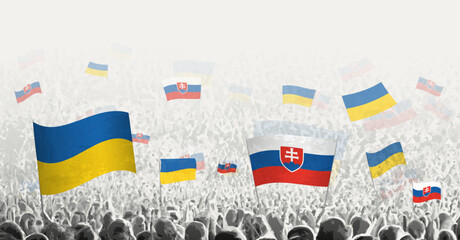 People waving flag of Slovakia and Ukraine, symbolizing Slovakia solidarity for Ukraine.