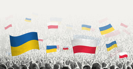 People waving flag of Poland and Ukraine, symbolizing Poland solidarity for Ukraine.