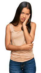 Beautiful hispanic woman wearing casual clothes thinking looking tired and bored with depression problems with crossed arms.