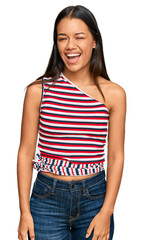 Fototapeta premium Beautiful hispanic woman wearing casual clothes winking looking at the camera with sexy expression, cheerful and happy face.