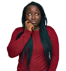 Young black woman with braids wearing casual clothes serious face thinking about question with hand...