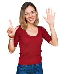 Young blonde girl wearing casual clothes showing and pointing up with fingers number seven while smiling confident and happy.