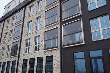 Close up of new modern beige and brown building during the day with no people. Many windows. Tallinn, Estonia, Europe 2024.