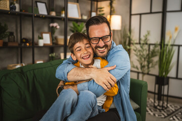 Dad hug son and share love with him spend time together at home