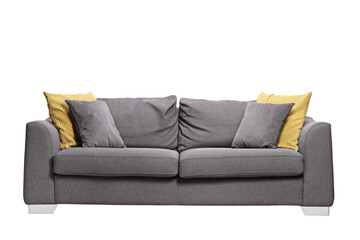 Studio shot of a cozy grey sofa with pillows