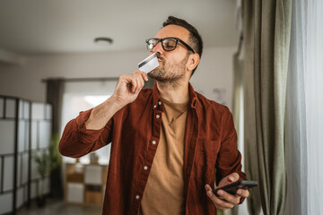 Portrait of adult man kiss credit card after online shopping