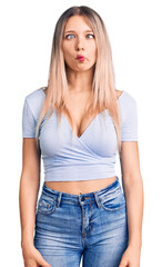 Obraz premium Young beautiful blonde woman wearing casual clothes making fish face with lips, crazy and comical gesture. funny expression.