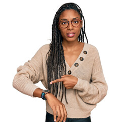African american woman wearing casual clothes in hurry pointing to watch time, impatience, upset...