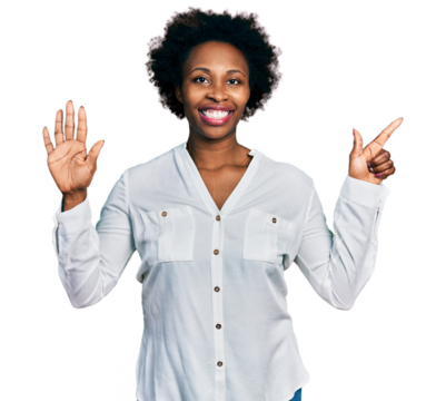 African american woman with afro hair wearing casual white t shirt showing and pointing up with fingers number seven while smiling confident and happy.