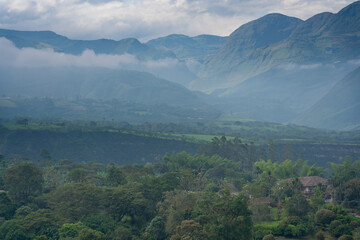 Photo of field and crops in a misty mountainous landscape in Colombia.
