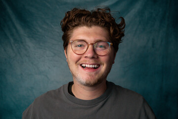 Man with Glasses Happy Portrait with Blue Background.