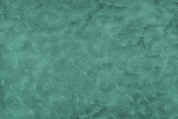 Texture of fluffy turquoise upholstery fabric or cloth. Fabric texture of artificial fur textile material. Canvas background. Decorative fabric for curtain, furniture, walls, clothes.