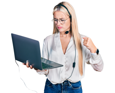 Beautiful blonde woman working with laptop wearing operator headset annoyed and frustrated shouting with anger, yelling crazy with anger and hand raised