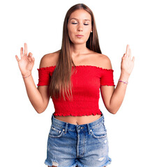 Young beautiful hispanic woman wearing casual clothes relax and smiling with eyes closed doing meditation gesture with fingers. yoga concept.