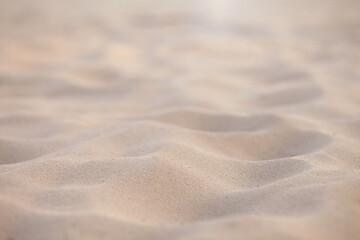 Closeup of sand with blurred background on a summer day, copy space or product. Summer background concept.