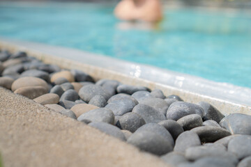 Stones decorating the edge of a luxury outdoor pool