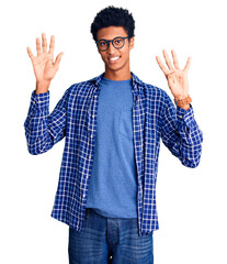 Naklejka premium Young african american man wearing casual clothes and glasses showing and pointing up with fingers number nine while smiling confident and happy.
