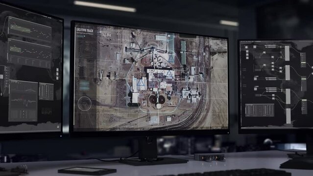 Military radar tech searching for the location of a target. Military radar tech identifying position of a chemical factory. Military radar tech collects coordinates information of the target location.