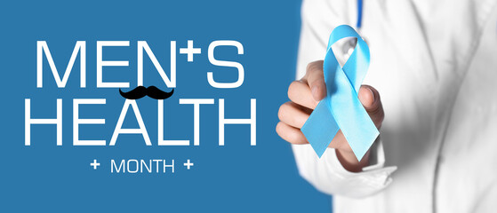 Female doctor holding blue ribbon on color background, closeup. Cancer awareness concept