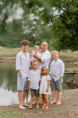 Fototapeta premium large family walks near the lake in the summer