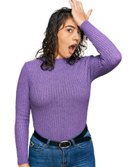 Young hispanic woman wearing casual clothes surprised with hand on head for mistake, remember error. forgot, bad memory concept.