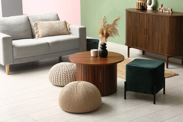 Interior of modern living room with coffee table and poufs