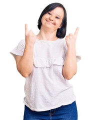 Brunette woman with down syndrome wearing casual white tshirt showing middle finger doing fuck you...