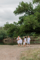 large family walks near the lake in the summer. High quality photo