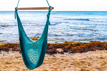 Hammock on a tropical paradisiacal beach in the Caribbean Mexico.
