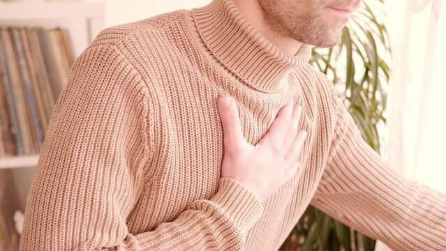 young man experiences experiences sudden chest pain behind sternum, clutching chest, Arterial hypertension, Myocarditis or Arrhythmia, heart disease experiences, Risk factors