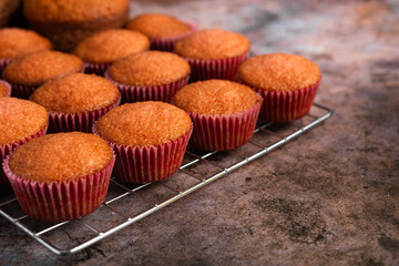 Freshly baked cupcakes on pastry table.
