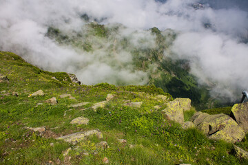 The natural background is beautiful green hills with a white cloud and a copy space on Krasnaya Polyana in Russia