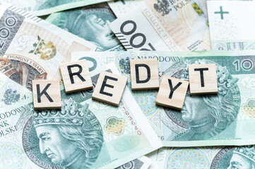 Polish Currency and Credit Concept with Scrabble Letters on Banknotes and word "Kredyt"